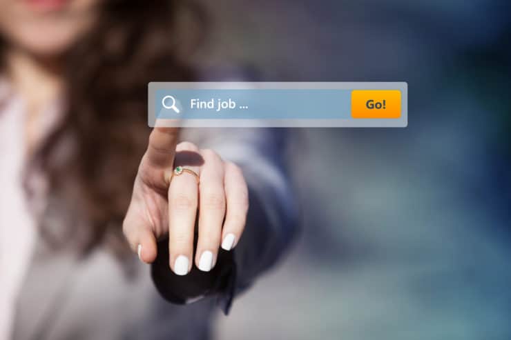 A woman is poitning at a screen that says job search.